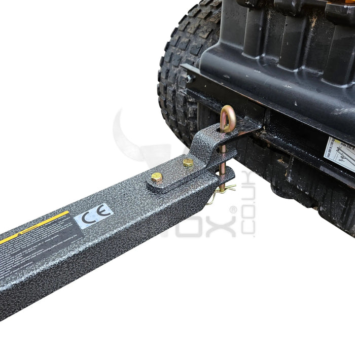 An image of an Iron Ox® 'MT' - Tipping Trailer 400lb attached to a tow truck hauling a trailer.