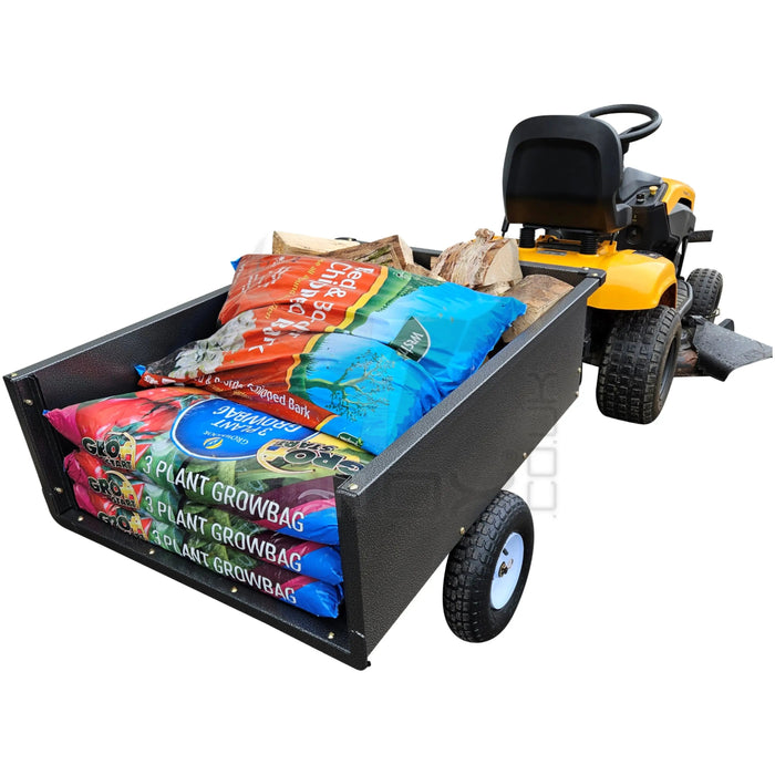 A lawn mower with a bag of Iron Ox® 'MT' - Tipping Trailer 400lb fertilizer on it.
