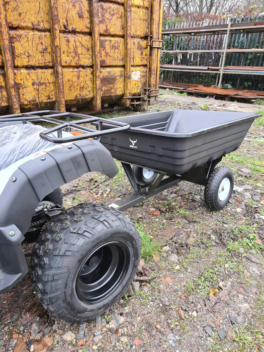 An ATV with an Iron Ox® Haul 4 - Tipping Trailer 400lb attached to it.
