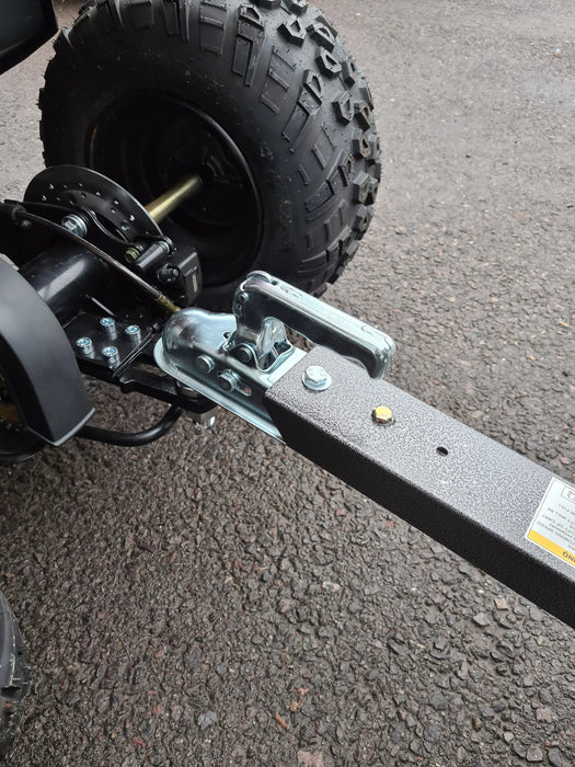 A black Iron Ox® Haul 4 - Tipping Trailer 400lb with a trailer attached to it for hauling purposes.