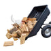 A black Iron Ox Haul 6 - Tipping Trailer 600lb with logs on it.