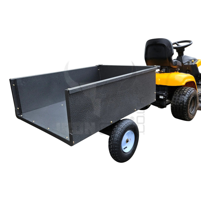 A lawn mower with an Iron Ox® 'MT' - Tipping Trailer 400lb attached to it.