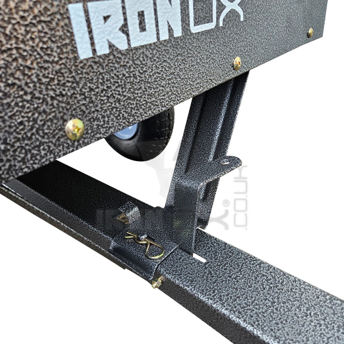 The Iron Ox® 'MT' - Tipping Trailer 400lb is attached to a metal frame, resembling a dump cart.
