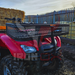 A heavy-duty red ATV with a ATV Front Basket Rack Universal Fitment on it.