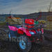 A pink ATV with an ATV Rear Basket Rack Universal Fitment is parked in a field.