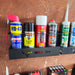 Various maintenance sprays and adhesives organized in an Aerosol Can Holder on a shelf, enhancing the workshop storage.