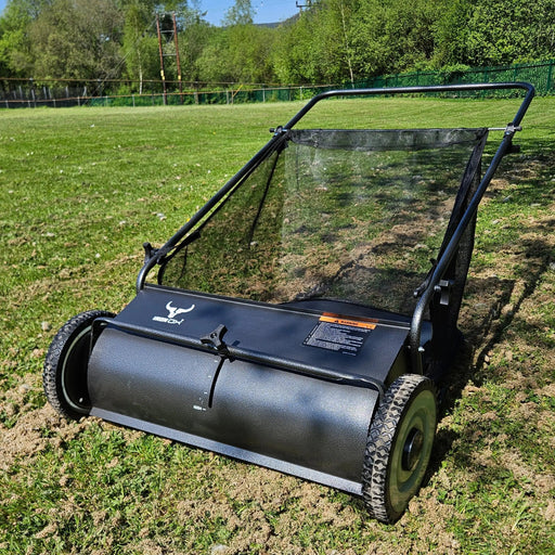 26-inch push lawn sweeper with large debris hopper on green grass
