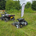 Heavy-duty tow behind topper mower attached to a quad bike cutting rough grass.