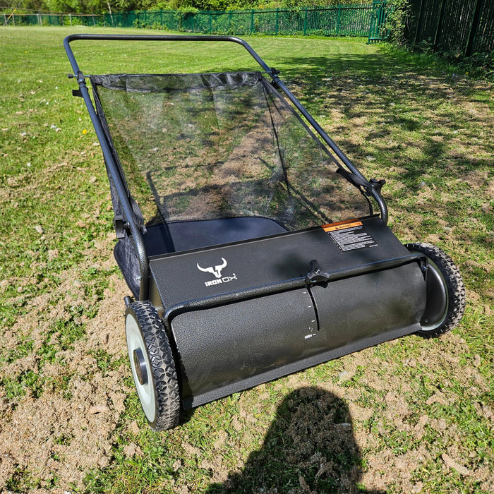 Close-up of 26-inch yard sweeper with large wheels and durable frame