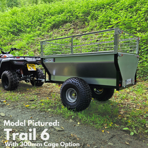 An All-Terrain ATV & Farm Tipping Trailer | Heavy-Duty Utility Trailer - Trail 6 with a 300mm cage option is hitched to an off-road vehicle on a gravel path amid greenery. Text: "Trail 6 with 300mm Cage Option.