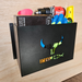 The General Purpose Metal Storage Box - Large elegantly holds a drill, gloves, book, and level against a wooden background, serving as the perfect storage solution.