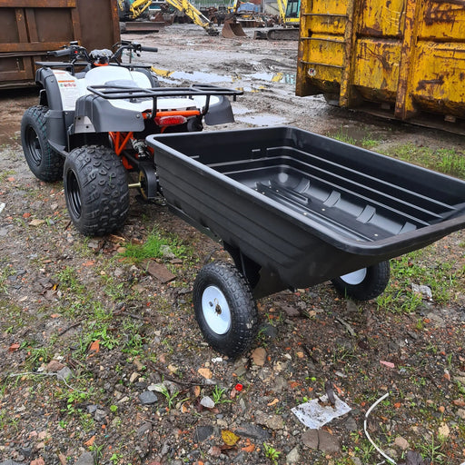 A black Iron Ox® Haul 4 - Tipping Trailer 400lb ATV with a trailer attached to it.