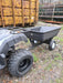 An ATV with an Iron Ox® Haul 4 - Tipping Trailer 400lb attached to it.